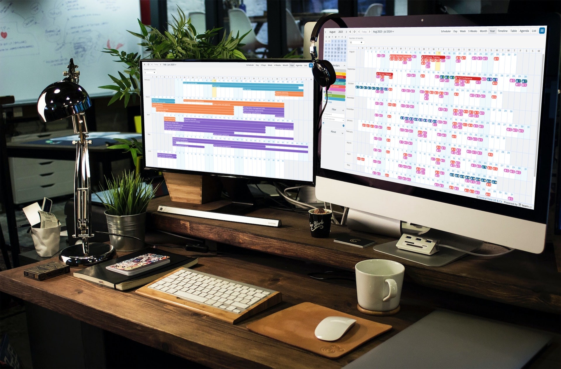 Two computer screens on a desk showing different calendar views of Teamup Year view